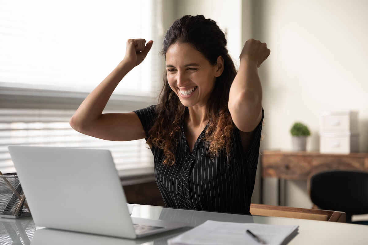 Donate a timeshare to charity: happy woman with her arms raised
