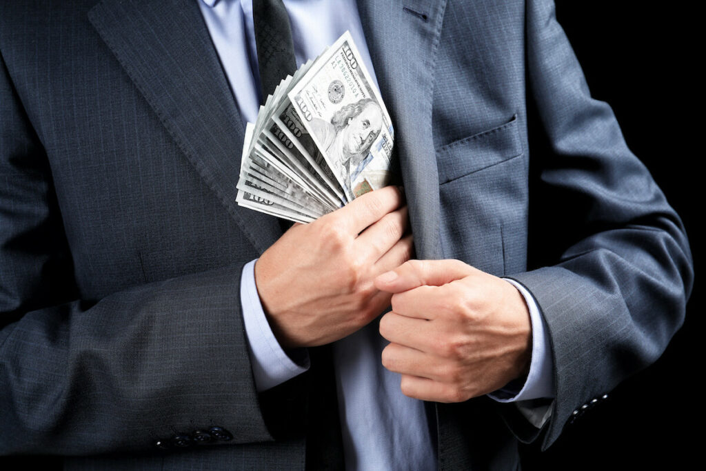 American Resort Development Association: man putting money in his suit pocket