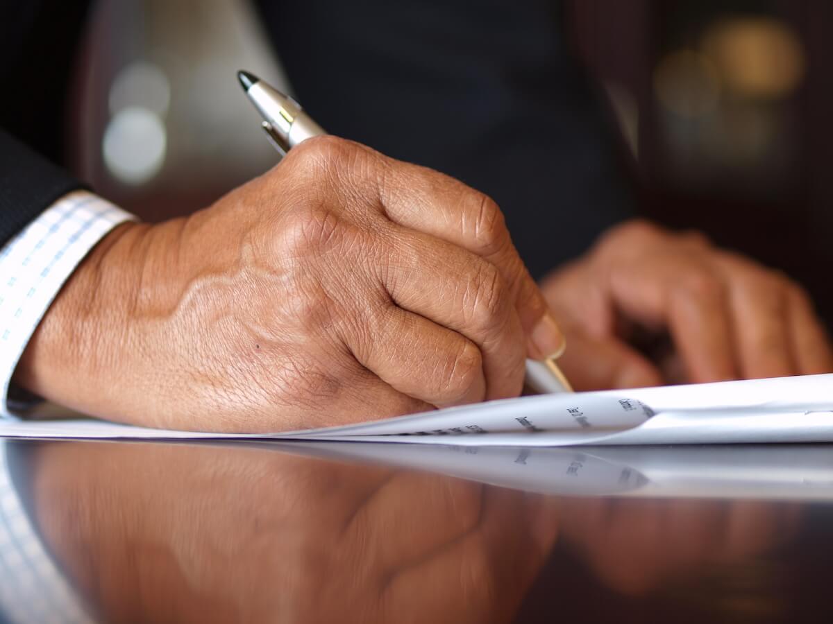 How to get rid of your timeshare: person signing a document