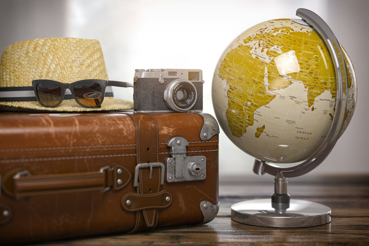 Hilton Grand Vacations Points Chart: globe, suitcase, hat, camera and sunglasses