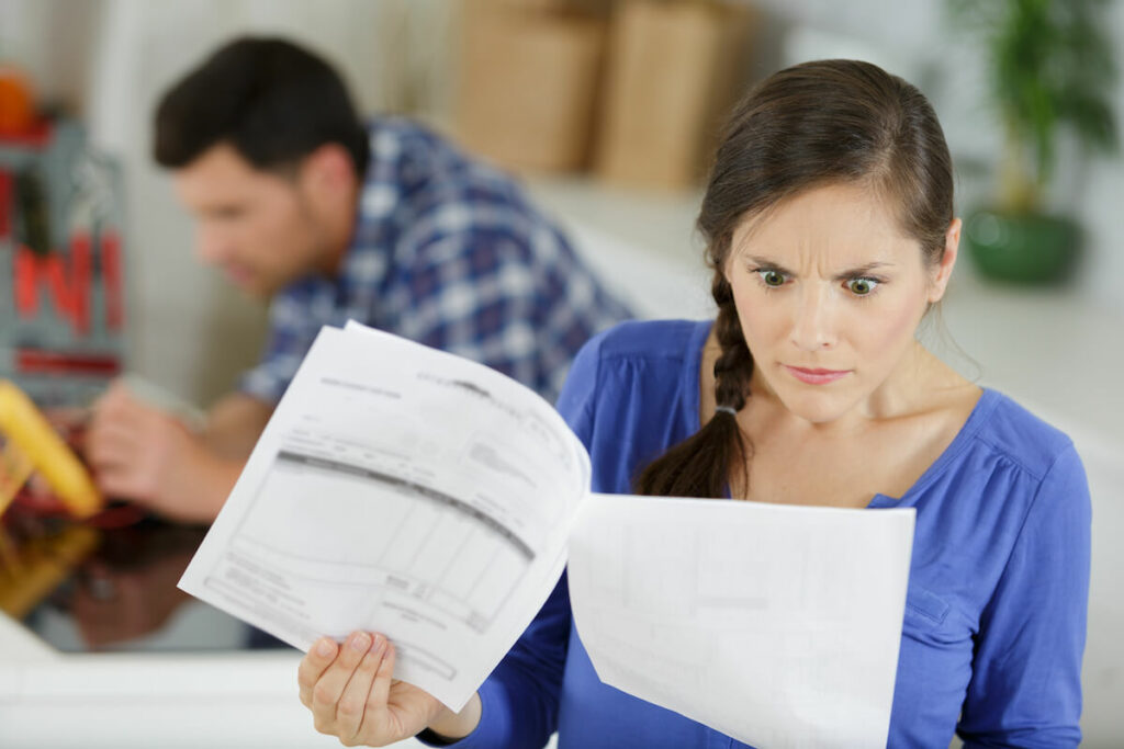 Average timeshare maintenance fees: shocked woman reading some documents