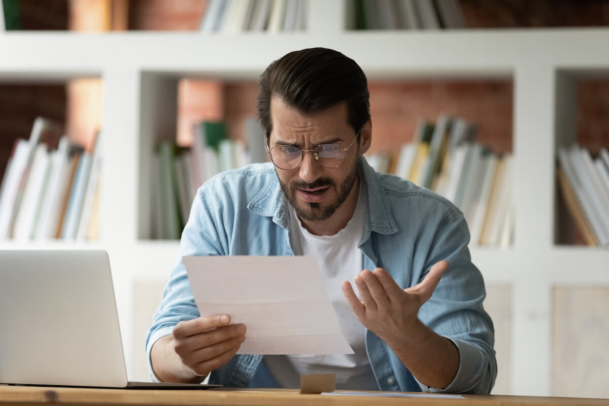 Average timeshare maintenance fees: stressed man reading a document