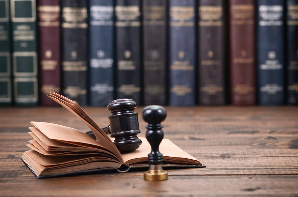 Notary seal, a gavel, and a book