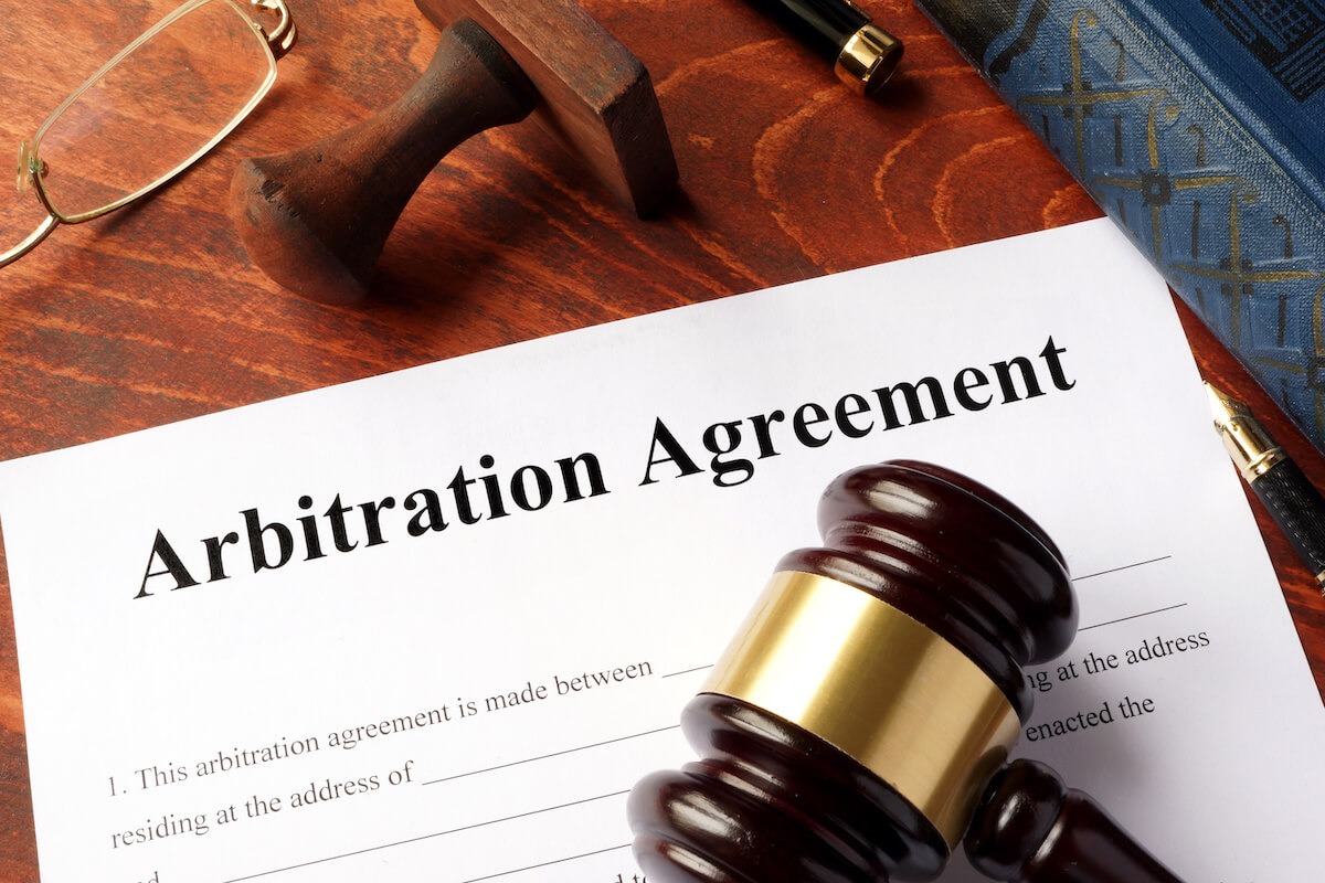 Class action lawsuit against timeshare companies: Arbitration Agreement form and a gavel