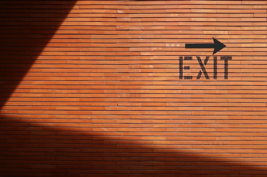 Why is it so hard to cancel a timeshare contract?: EXIT sign painted on the wall