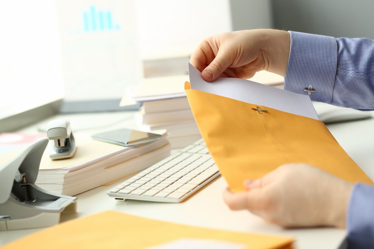 How to get out of Hilton Grand Vacation timeshare: entrepreneur holding a yellow envelope