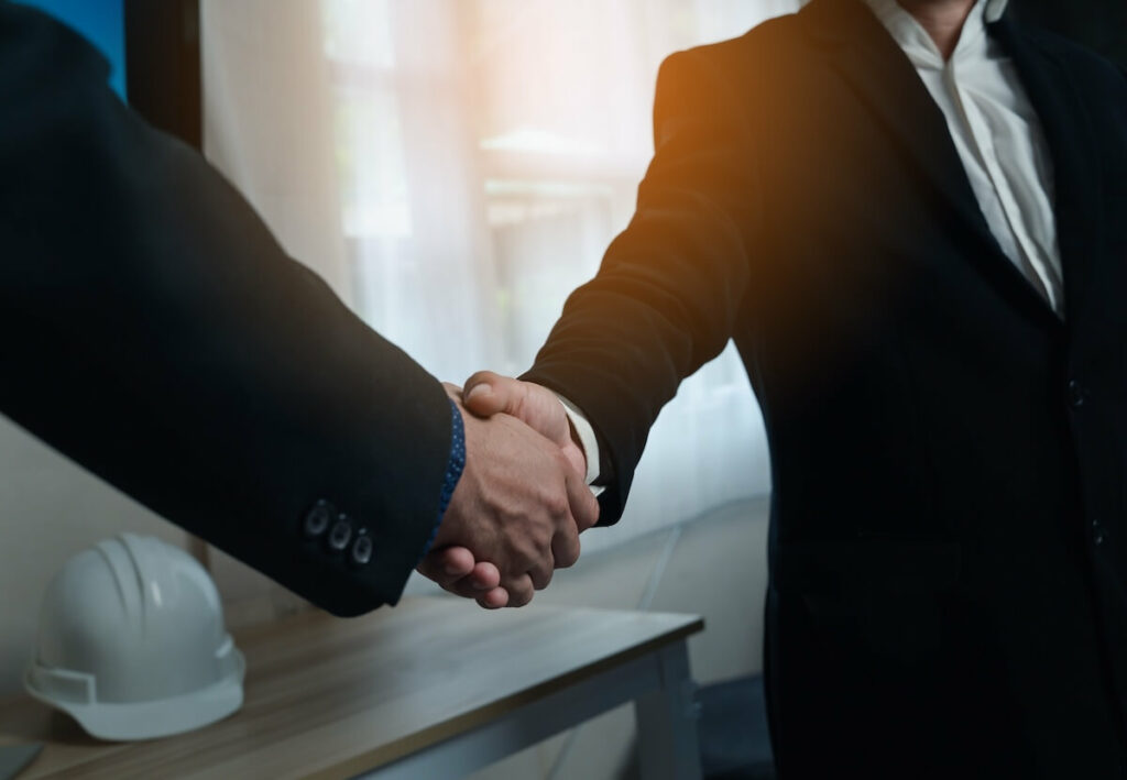 How to Choose a Reputable Timeshare Exit Company: close up shot of entrepreneurs shaking hands