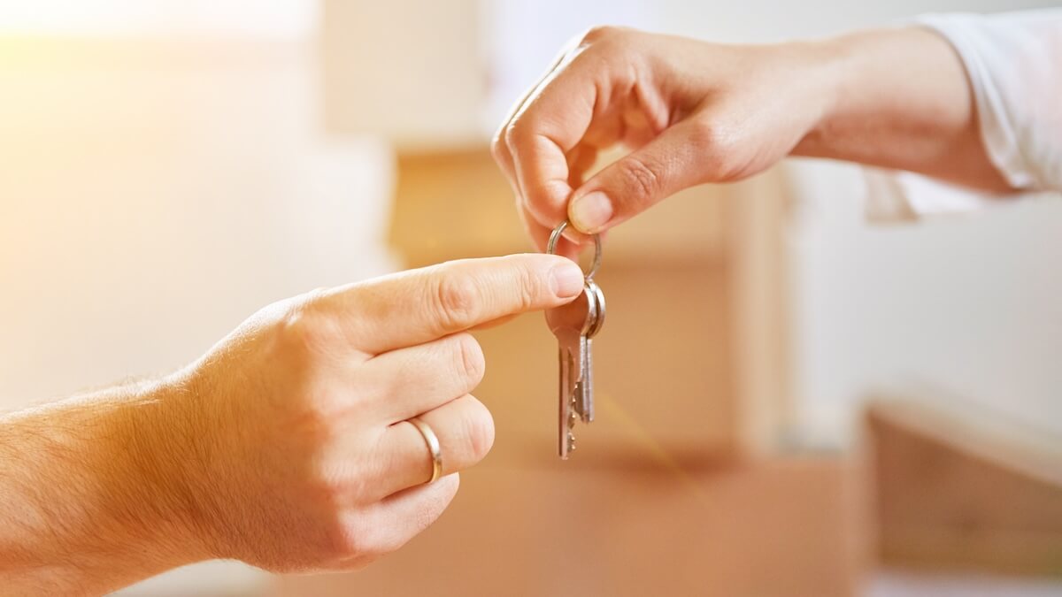 Person handing keys to another person