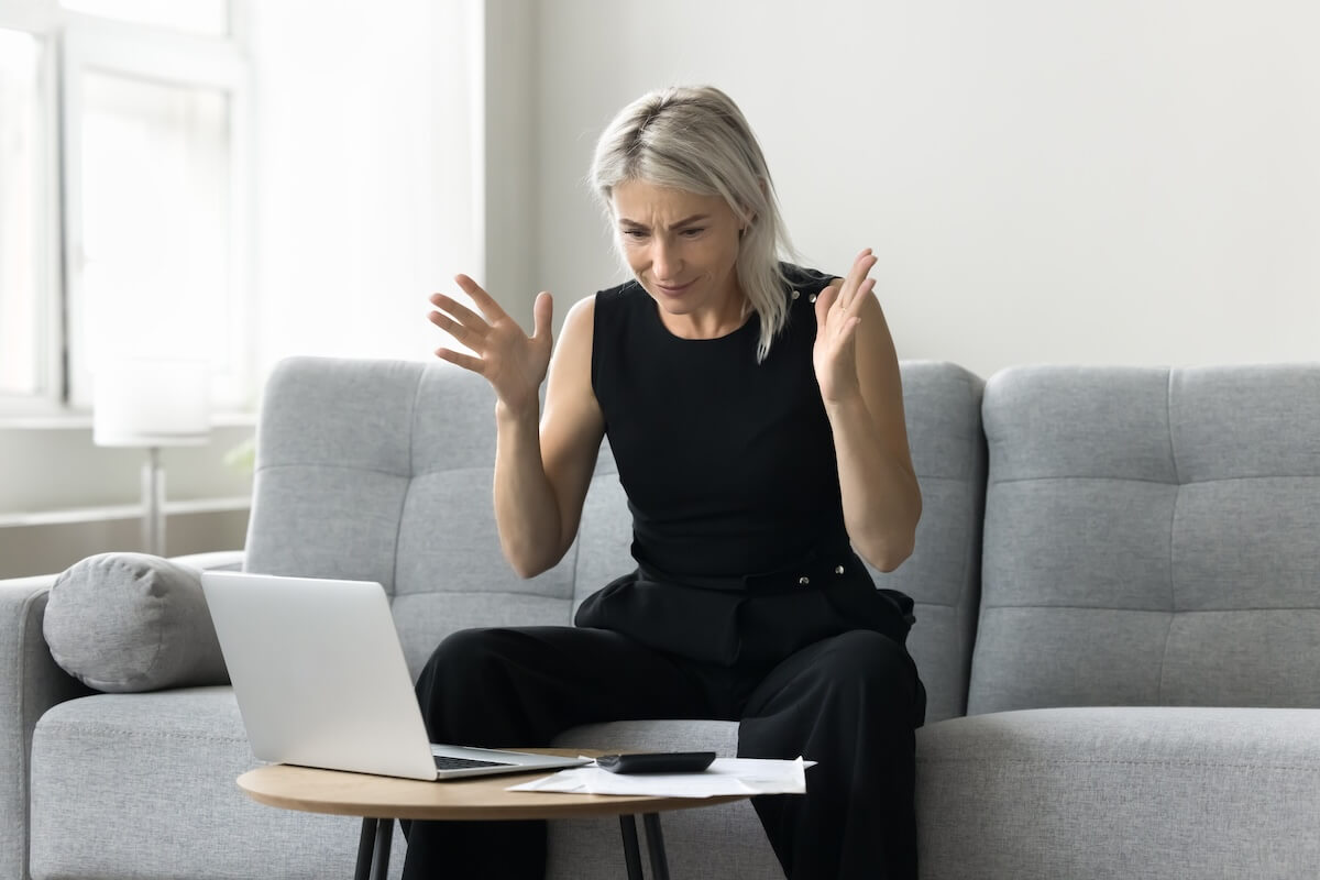 Can I sell my timeshare back to RCI: shocked woman looking at her laptop