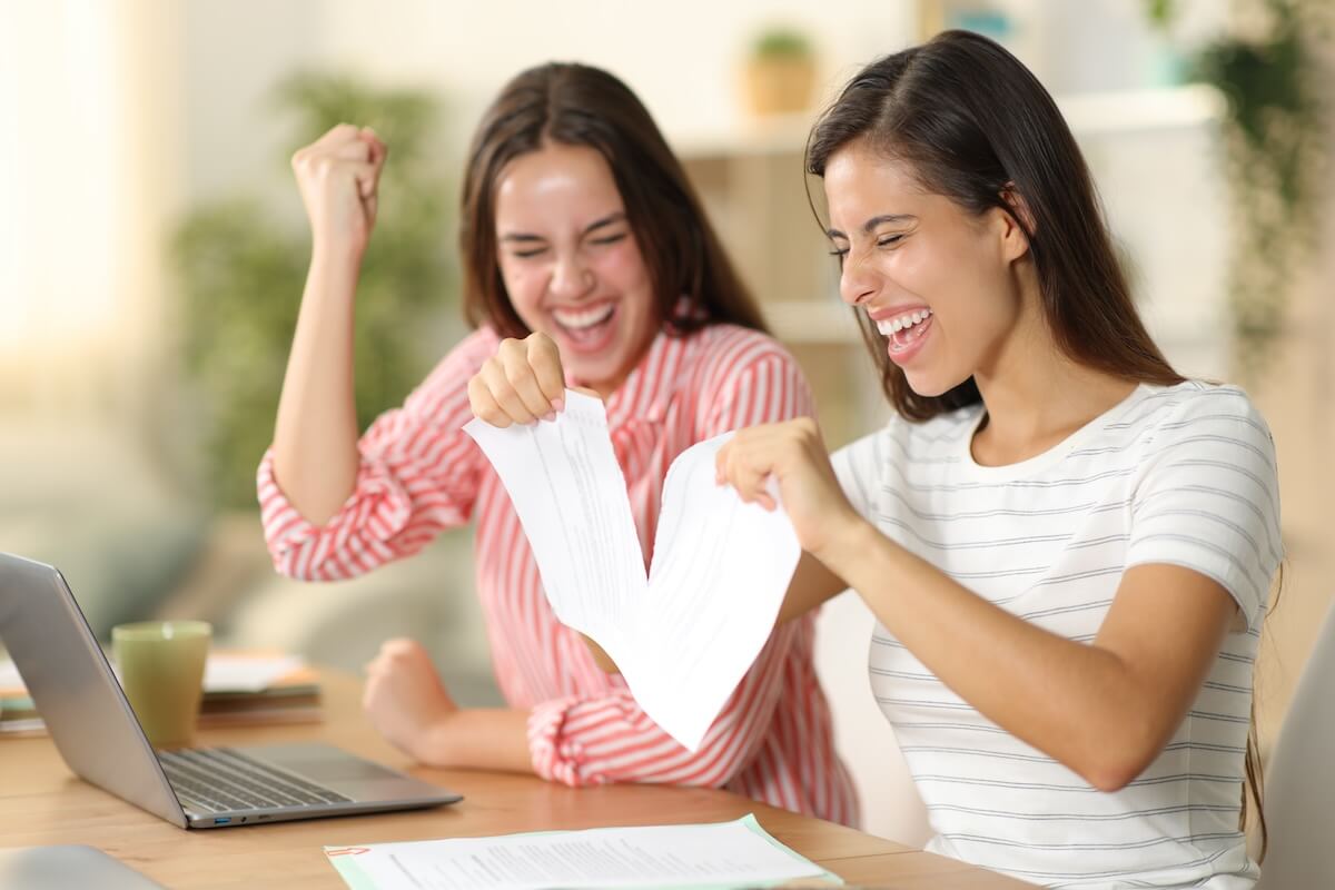 Woman happily tearing up a contract