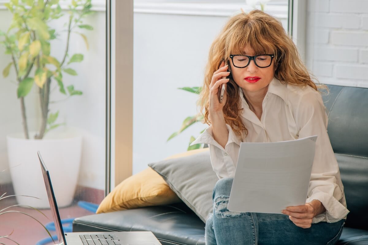 How to cancel Sapphire Resorts timeshare: woman talking on the phone while looking at a document