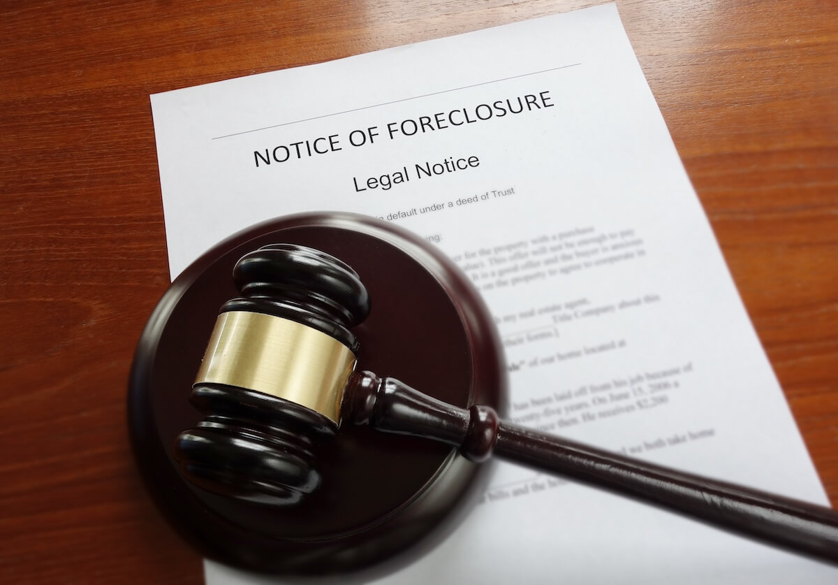 Notice of foreclosure document and a gavel on a table