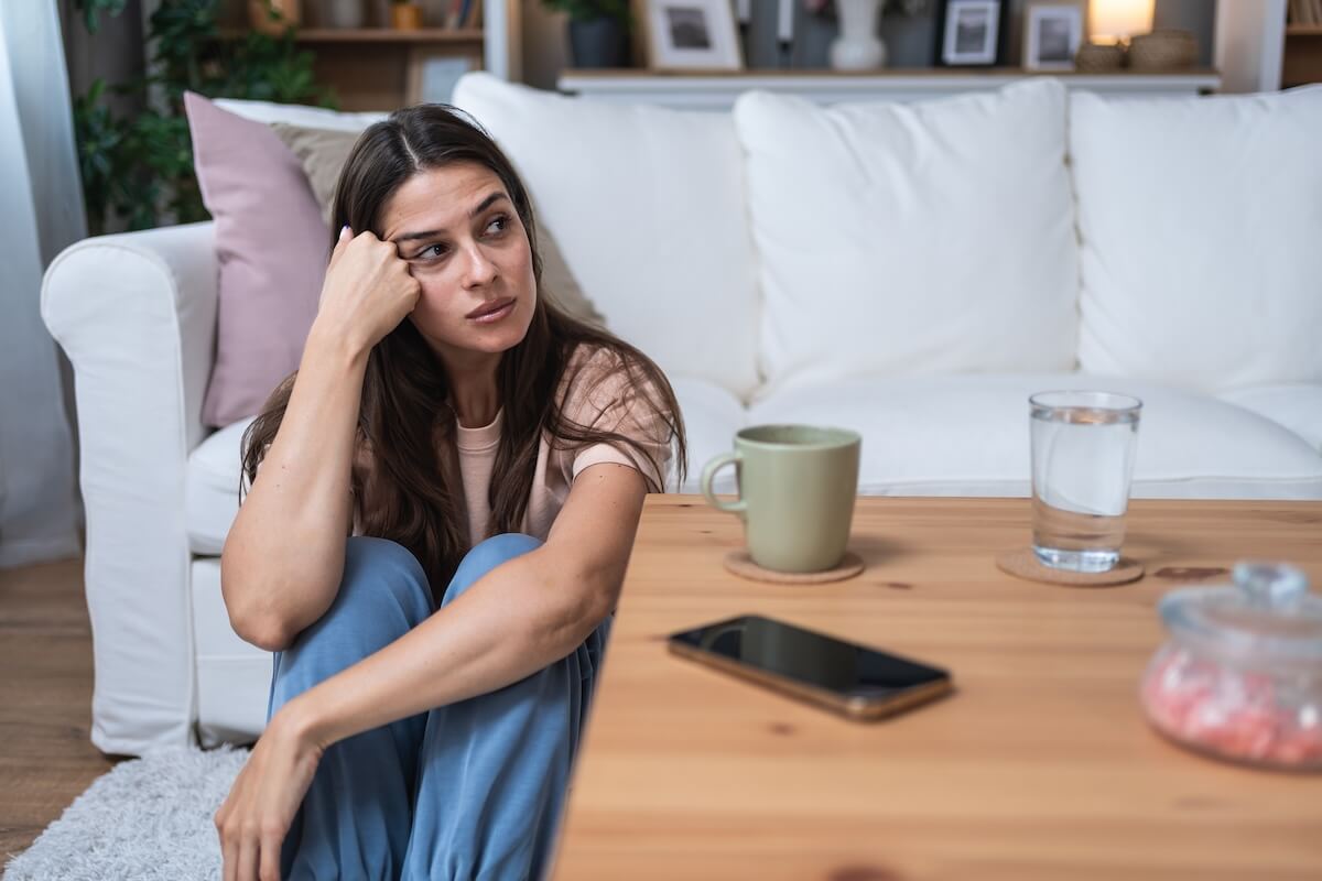 Stressed woman sitting on the floor