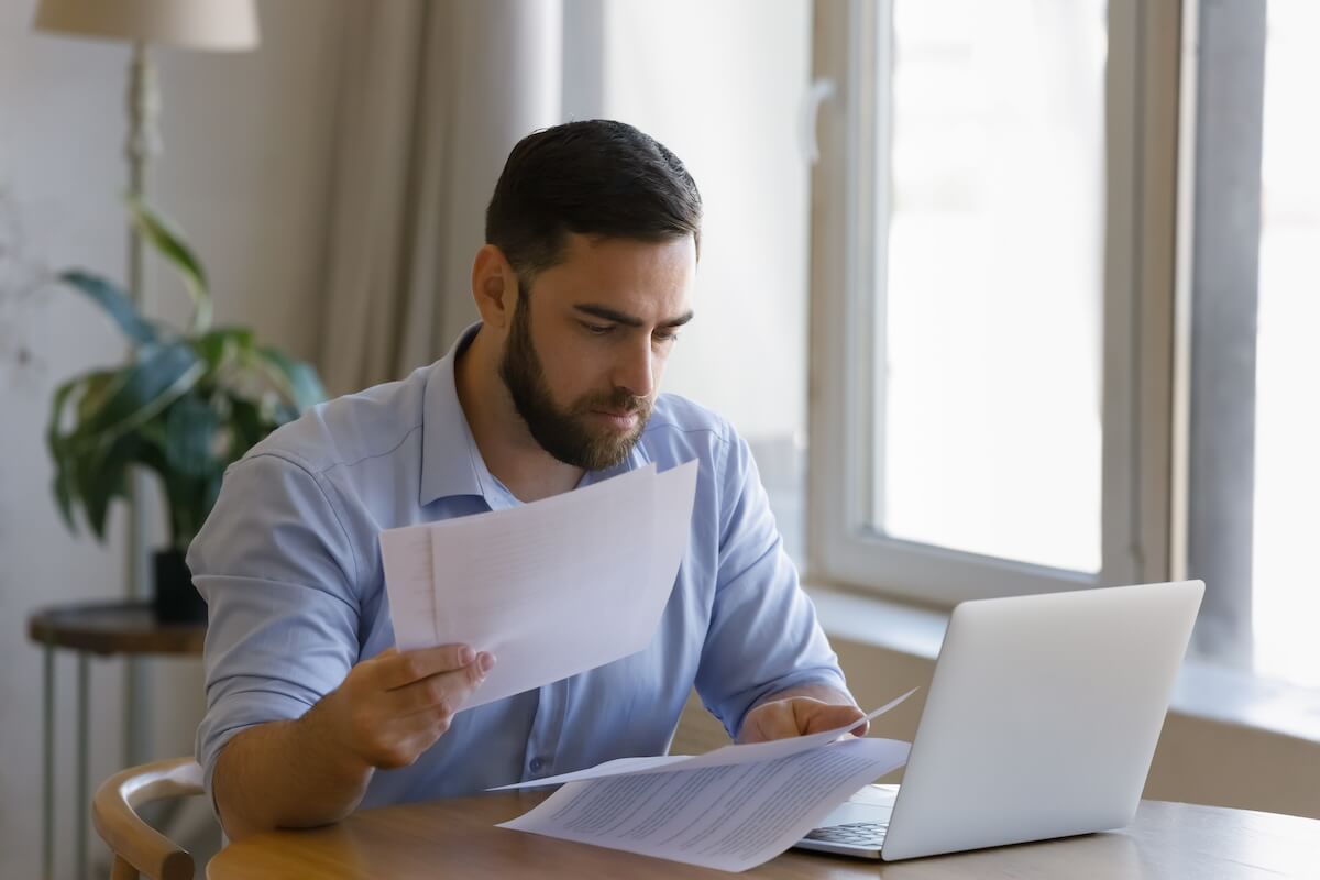 What is the cheapest way to get out of a timeshare?: man reading some documents