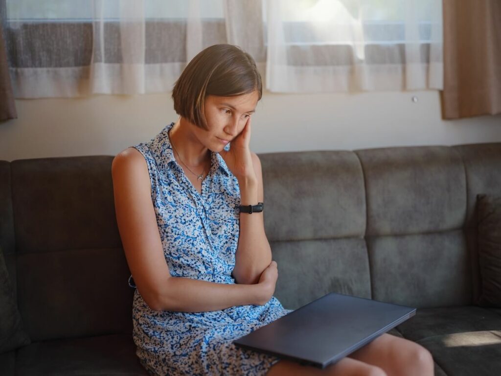 What is the best way to get out of a timeshare?: worried woman sitting on a couch