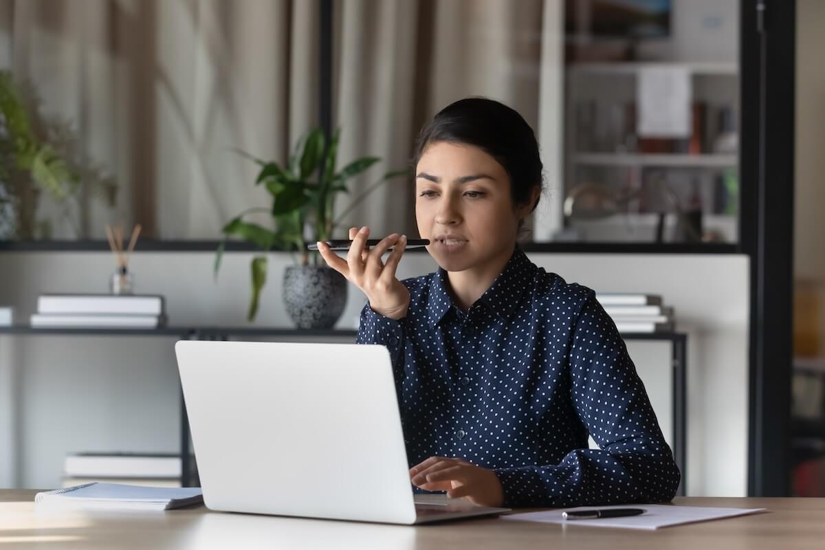 Entrepreneur talking on the phone while using her laptop