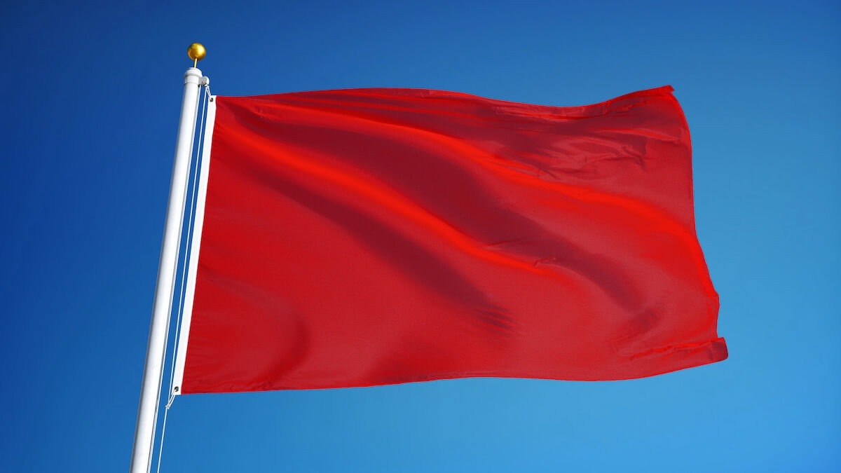 How to Avoid Timeshare Exit Scams: close up shot of a red flag