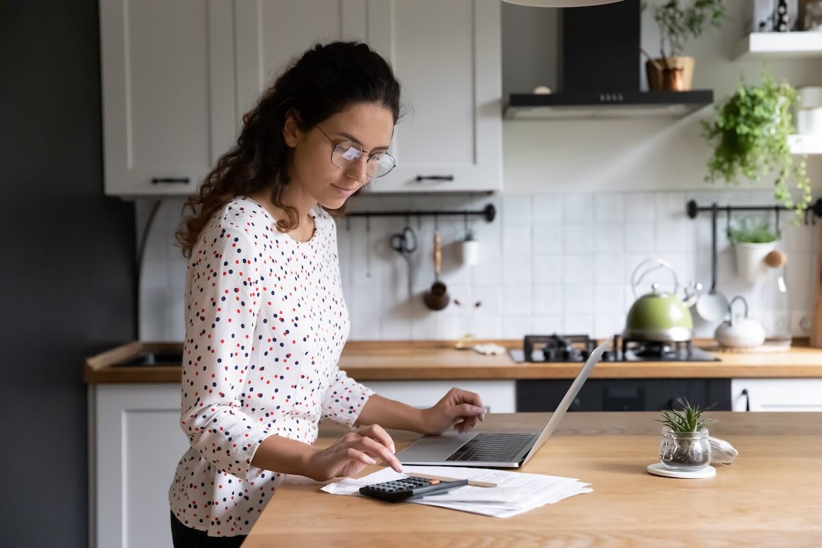 Understanding the Financial Implications of Exiting a Timeshare: woman wearing a pair of eyeglasses using a calculator