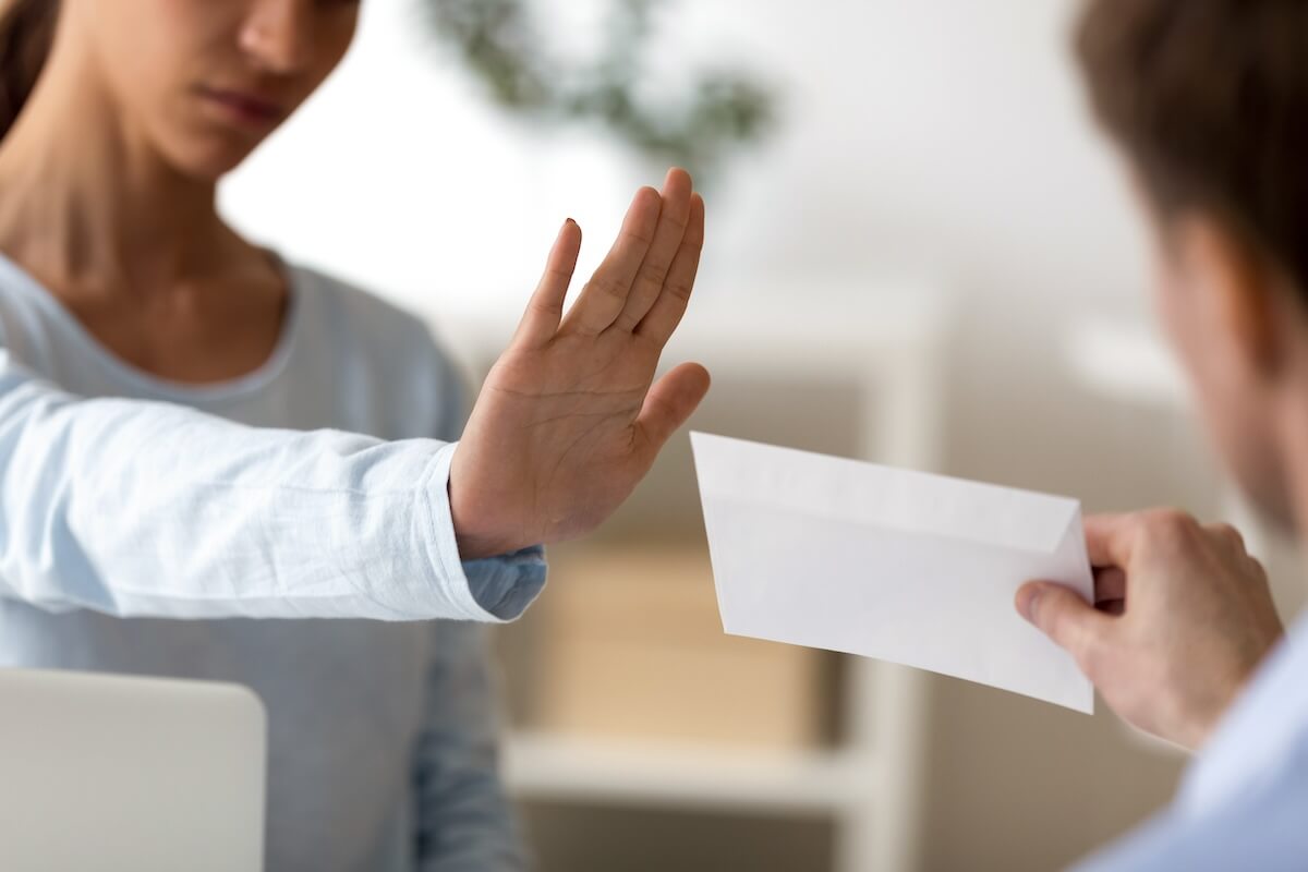 Woman refusing to take an envelope