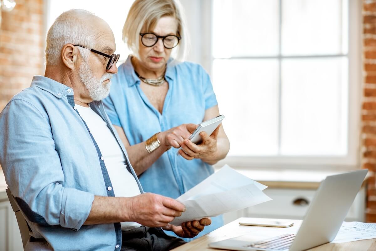 Senior couple using a calculator