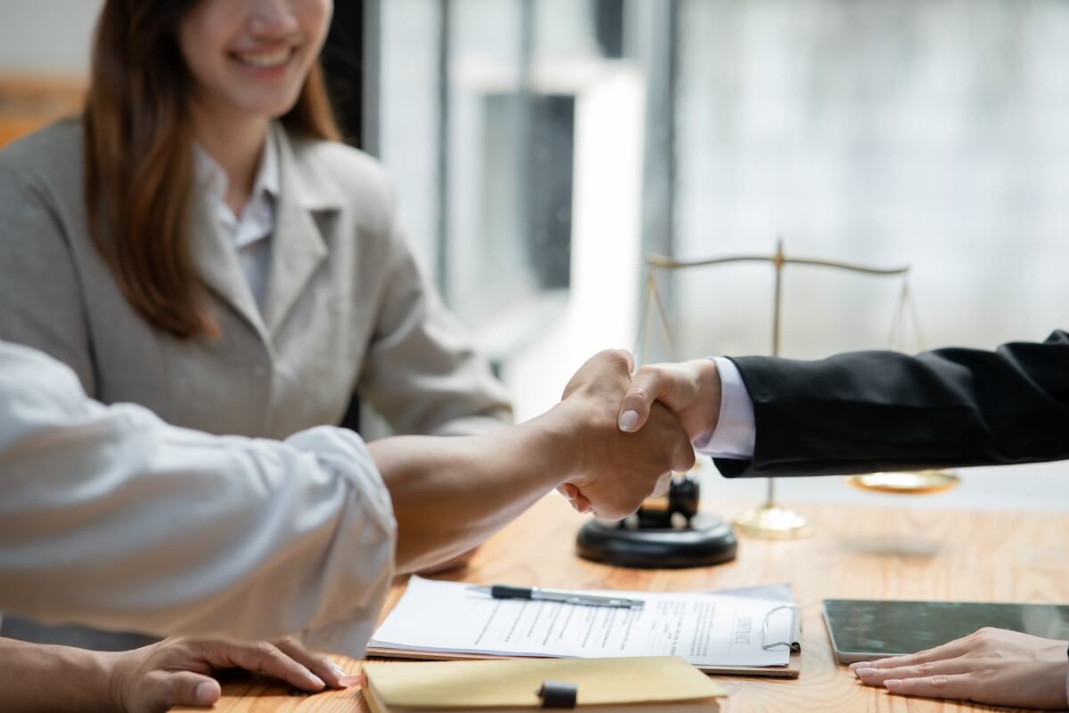 When to Consider Mediation for a Timeshare Exit Dispute: client shaking hands with his lawyer