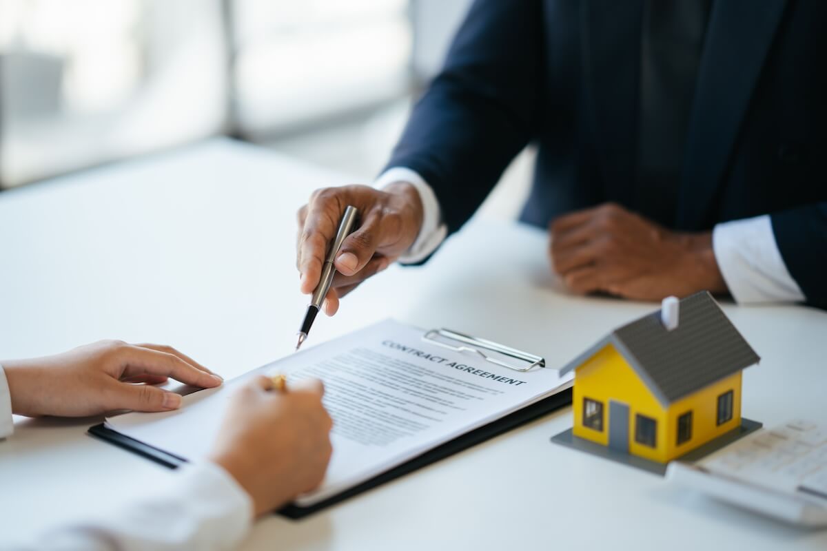 Real estate agent guiding his client through a contract