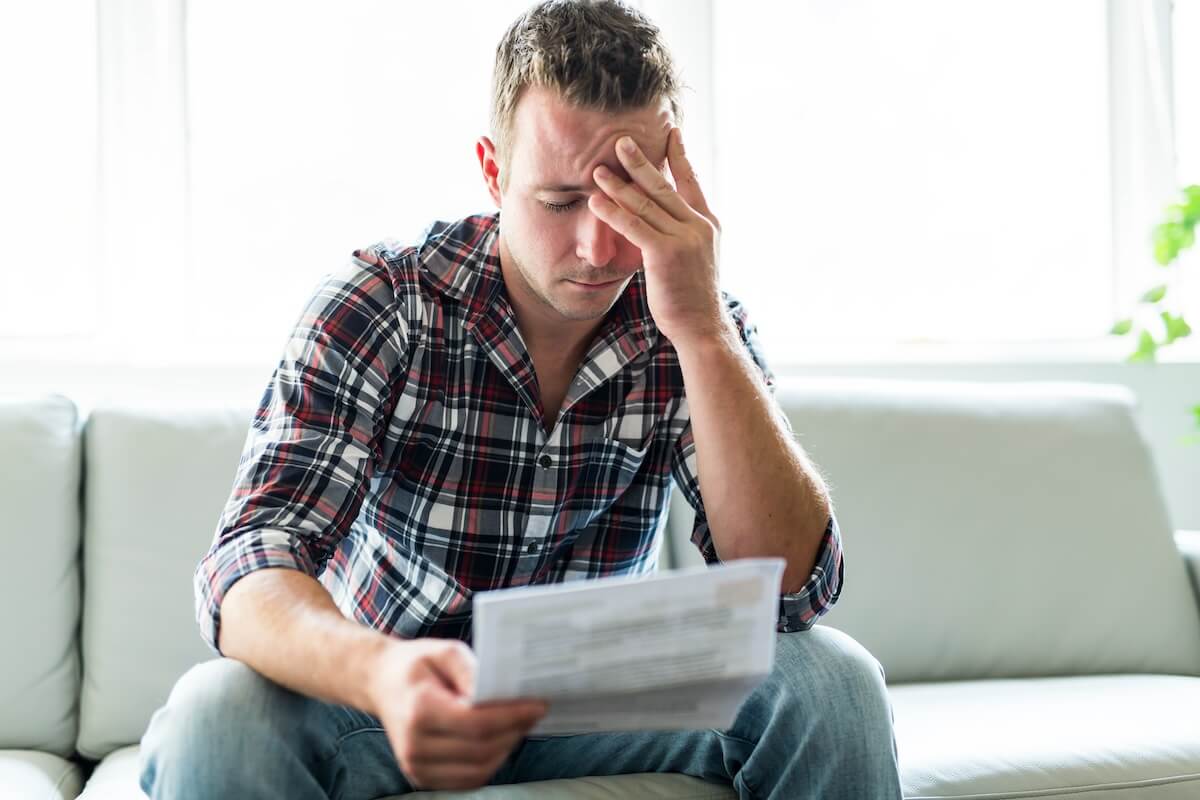 Stressed man reading a document