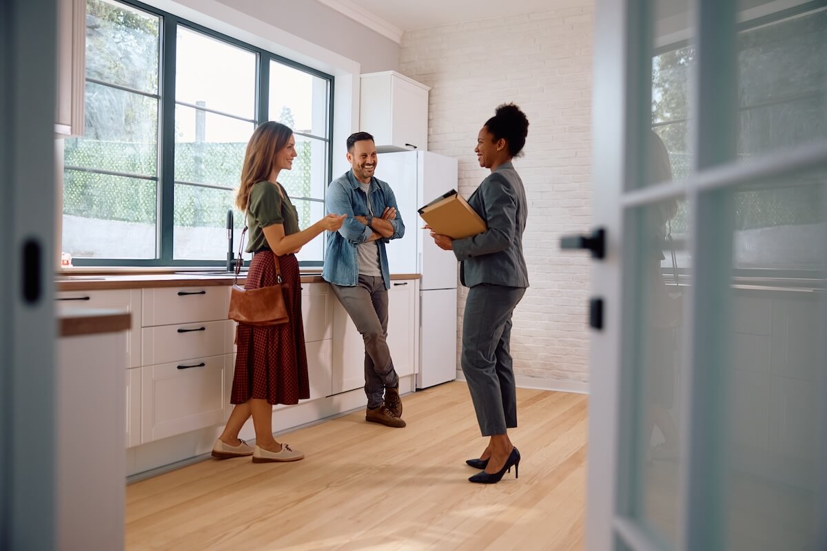 Couple talking to a real estate agent