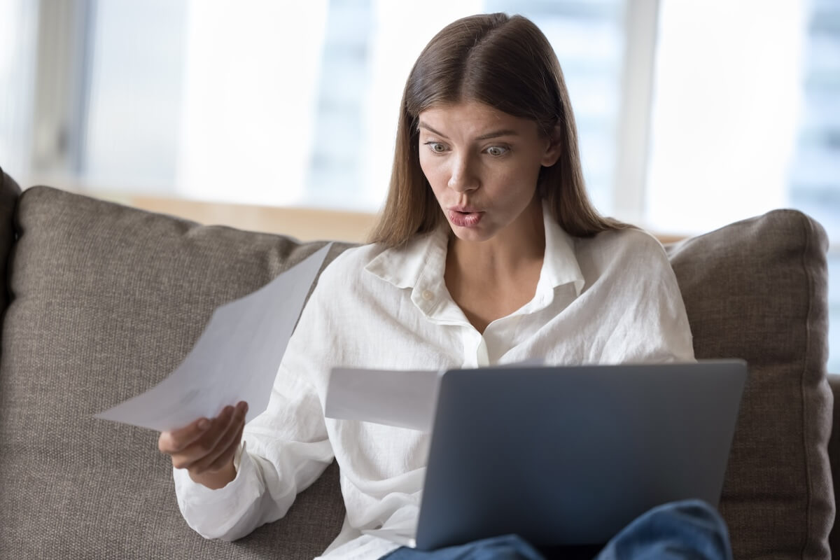 Shocked woman reading some documents