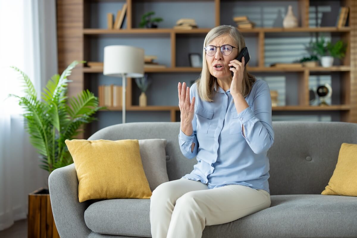 Stressed senior woman talking on the phone