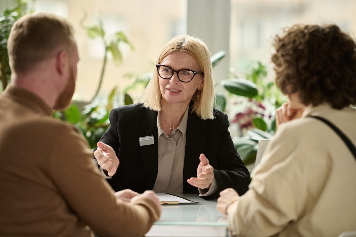 Real estate broker talking to her clients