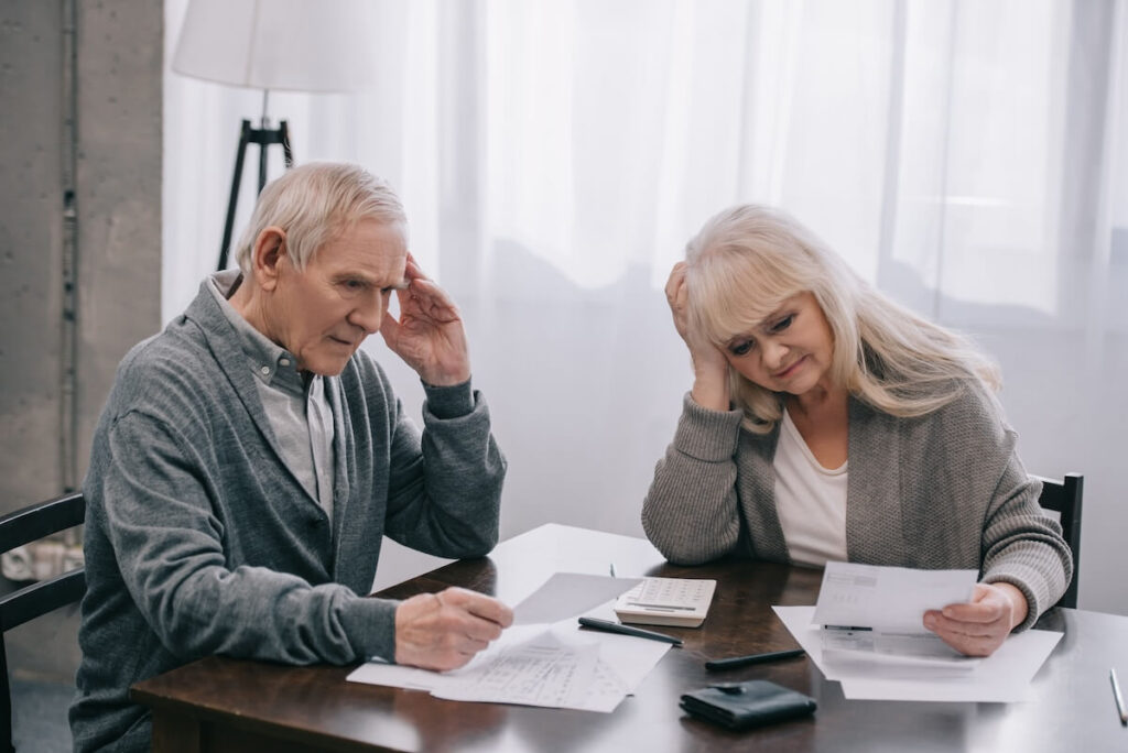 Regret buying a timeshare: stressed senior couple reading documents