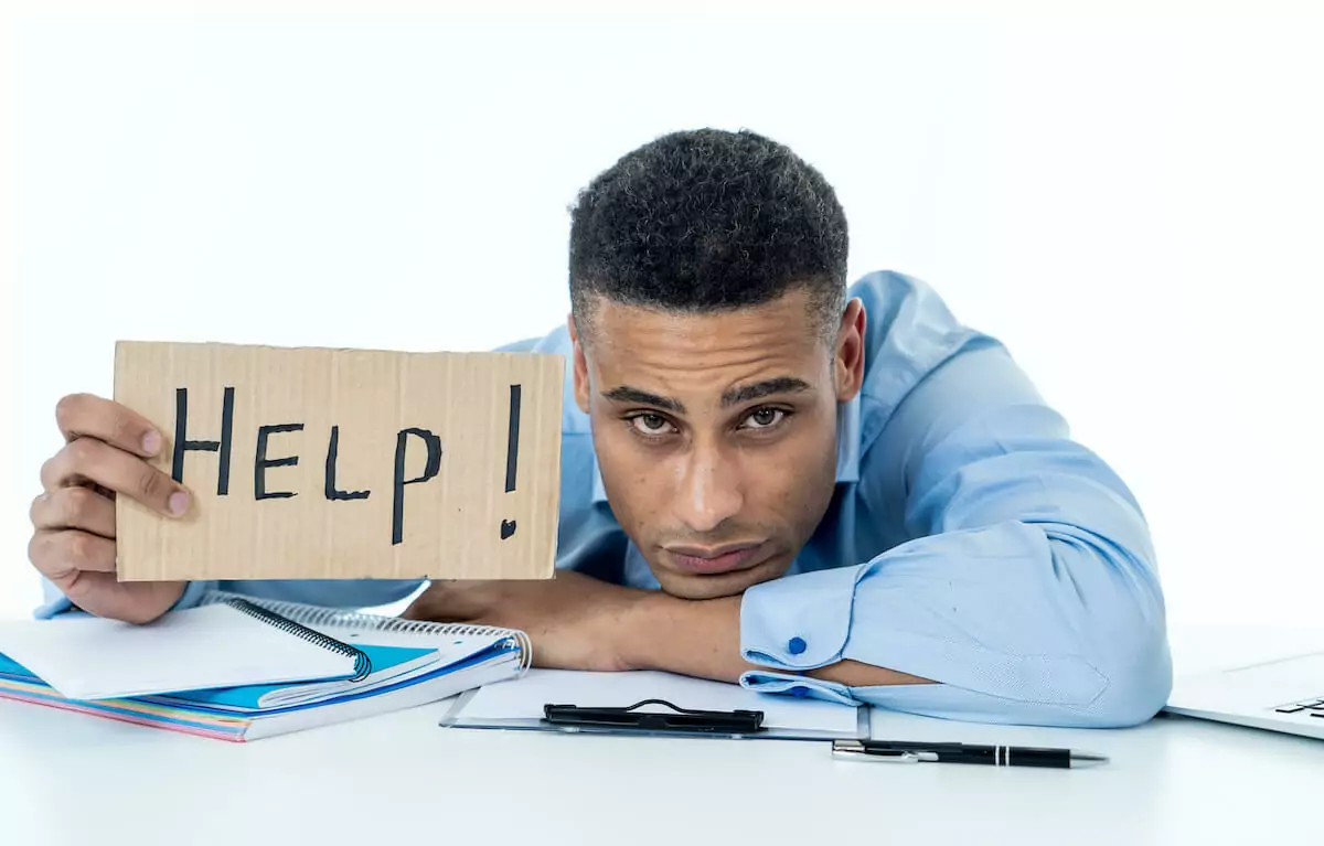 Man holding a Help! sign